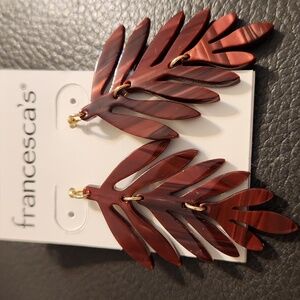 Burgundy dangling earrings.